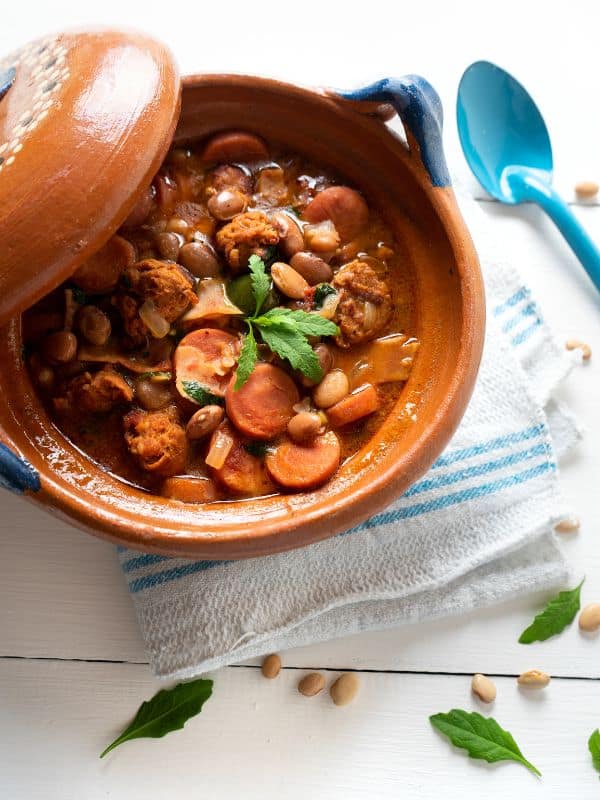 spanish baked bean soup with chorizo in a clay pot