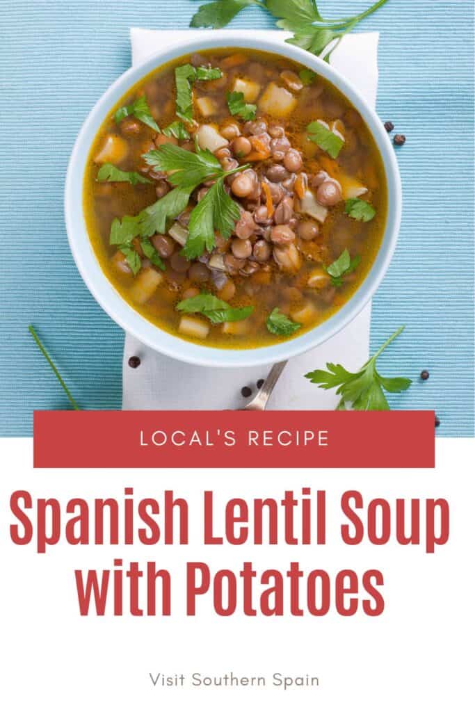 a pin with a bowl of Spanish lentil soup with potatoes on a blue table.