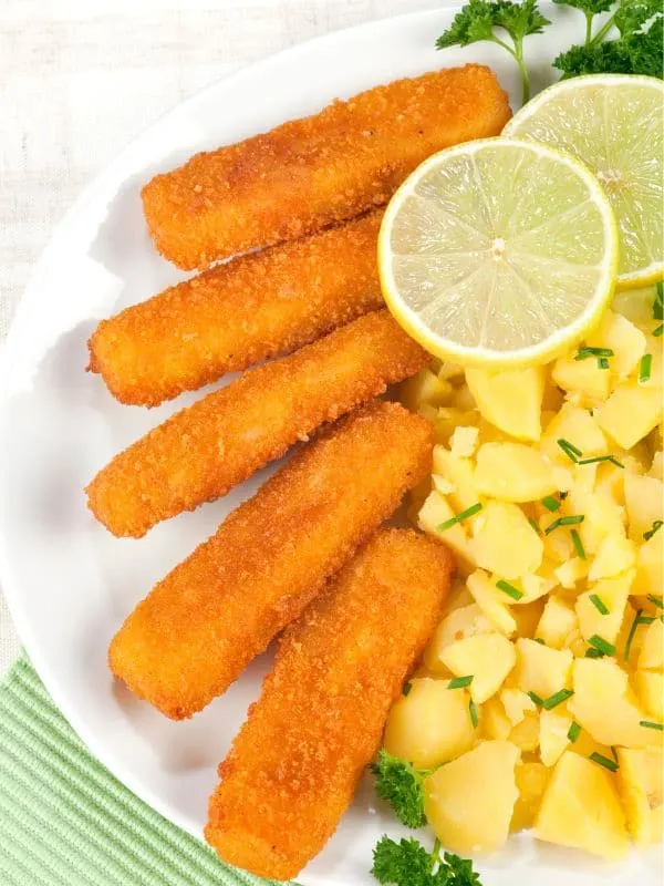 baby spanish mackerel sticks served with potatoes and lemon slices.