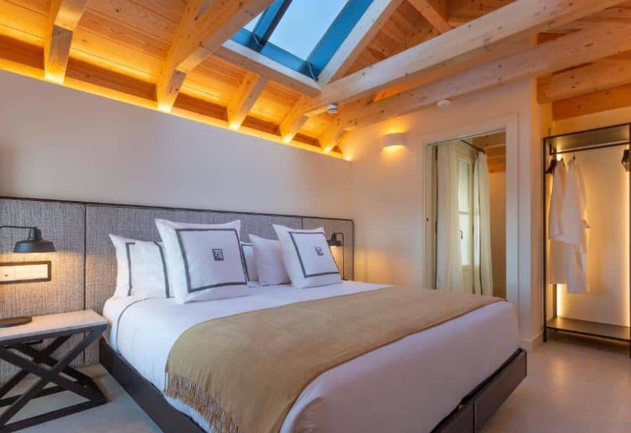 bedroom with robes and wooden ceilling at La Fonda Heritage Hotel Luxury, Relais & Châteaux, one of the best resorts in Marbella