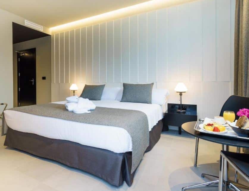 breakfast by the bed in a bedroom at Costa del Sol Torremolinos Hotel, Malaga