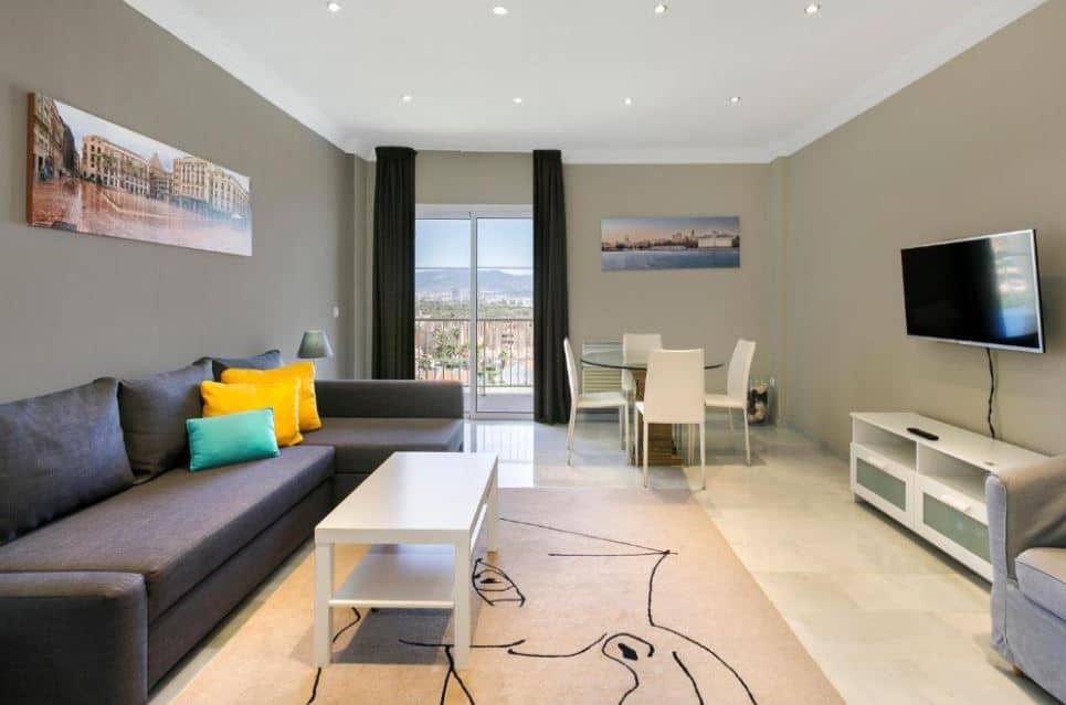 living room with sofa, TV and dining table at Sol Guadalmar, one of the top hotels in Malaga