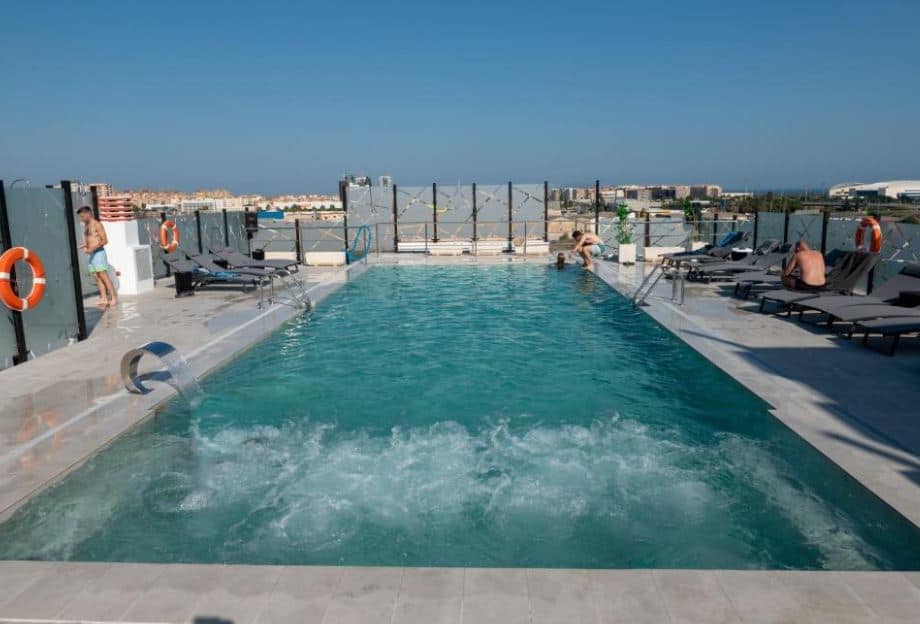 rooftop pool with sun lounges at Hotel Málaga Nostrum Airport