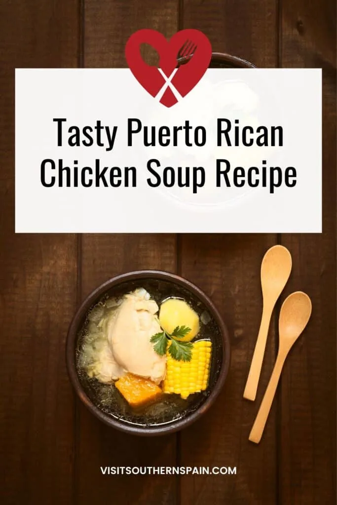 a pin with a puerto Rican Chicken Soup with corn on a wooden surface.