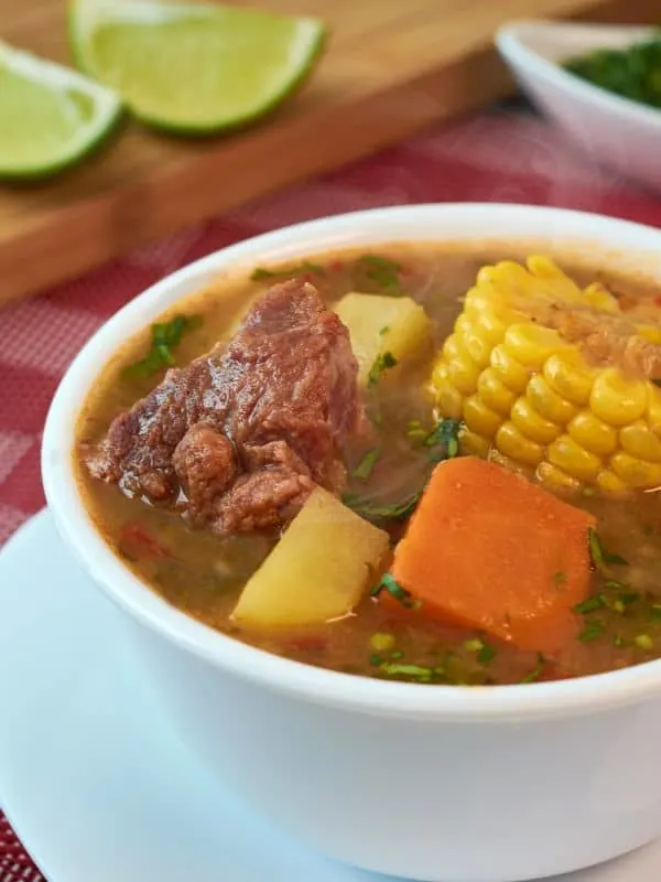 a bowl of homemade  oxtail soup with corn kernel and vegetables