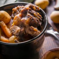 a bowl of instant pot oxtail on a wooden table.