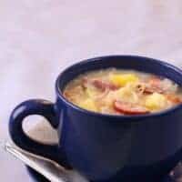 a cup of Spanish cabbage soup with ham and chicken