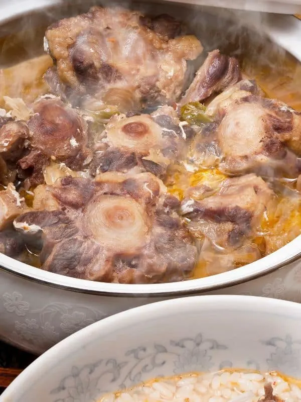 oxtails boiling in a pot for the oxtail noodle soup