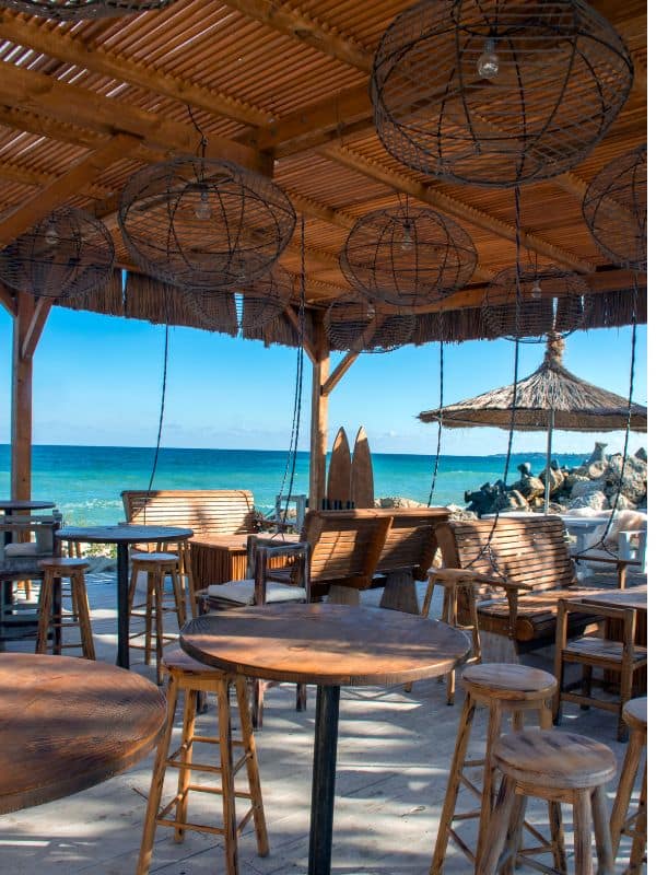 a beach bar in Marbella with wooden furniture