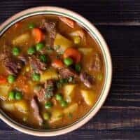 a bowl of easy oxtail soup recipe on a black wooden table