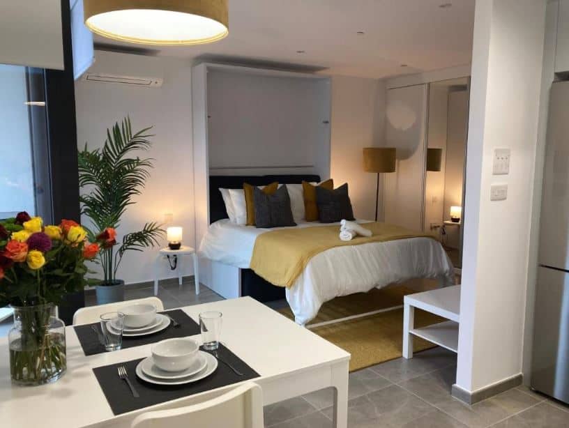 apartment with bedroom, sitting area and dining table at E1 Suites & Spa aparthotel style - Gym & Spa in Gibraltar
