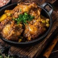 oxtail casserole in a cast iron on a wooden table