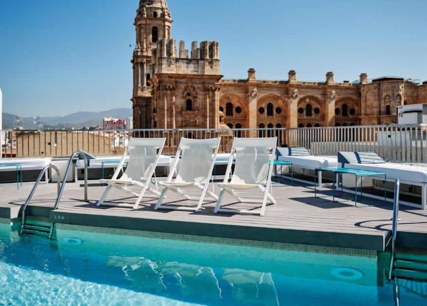 rooftop pool and lounge area with cathedral view at Molina Lario, one of the top hotels in Malaga