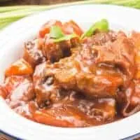 Traditional Oxtail recipe with potatoes and carrots in a white bowl
