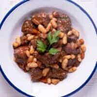 a bowl of oxtail and butter beans stew