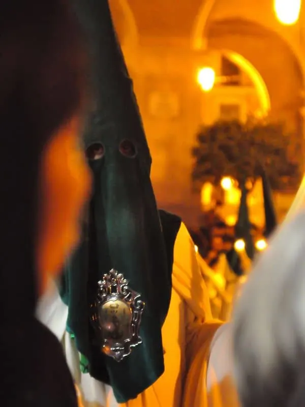 a man dressed with a hood as part of Easter what is the history of semana santa