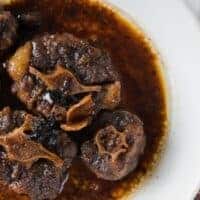 red wine braised oxtail served in a white plate