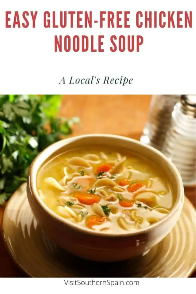 a pin with a clay bowl of gluten-free chicken noodle soup with parsley next to it.