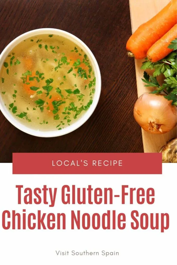 a pin with gluten-free chicken noodle soup in a bowl with vegetables next to it.