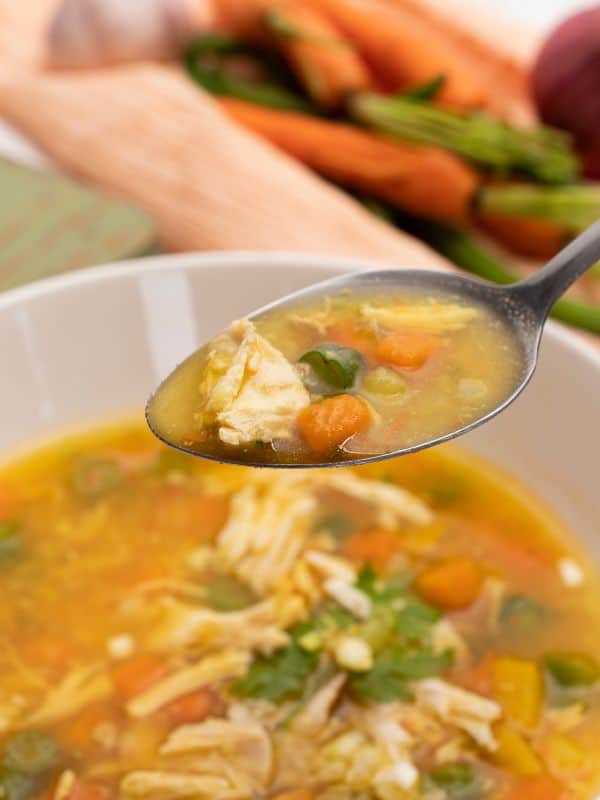 a spoon with chicken soup without noodles