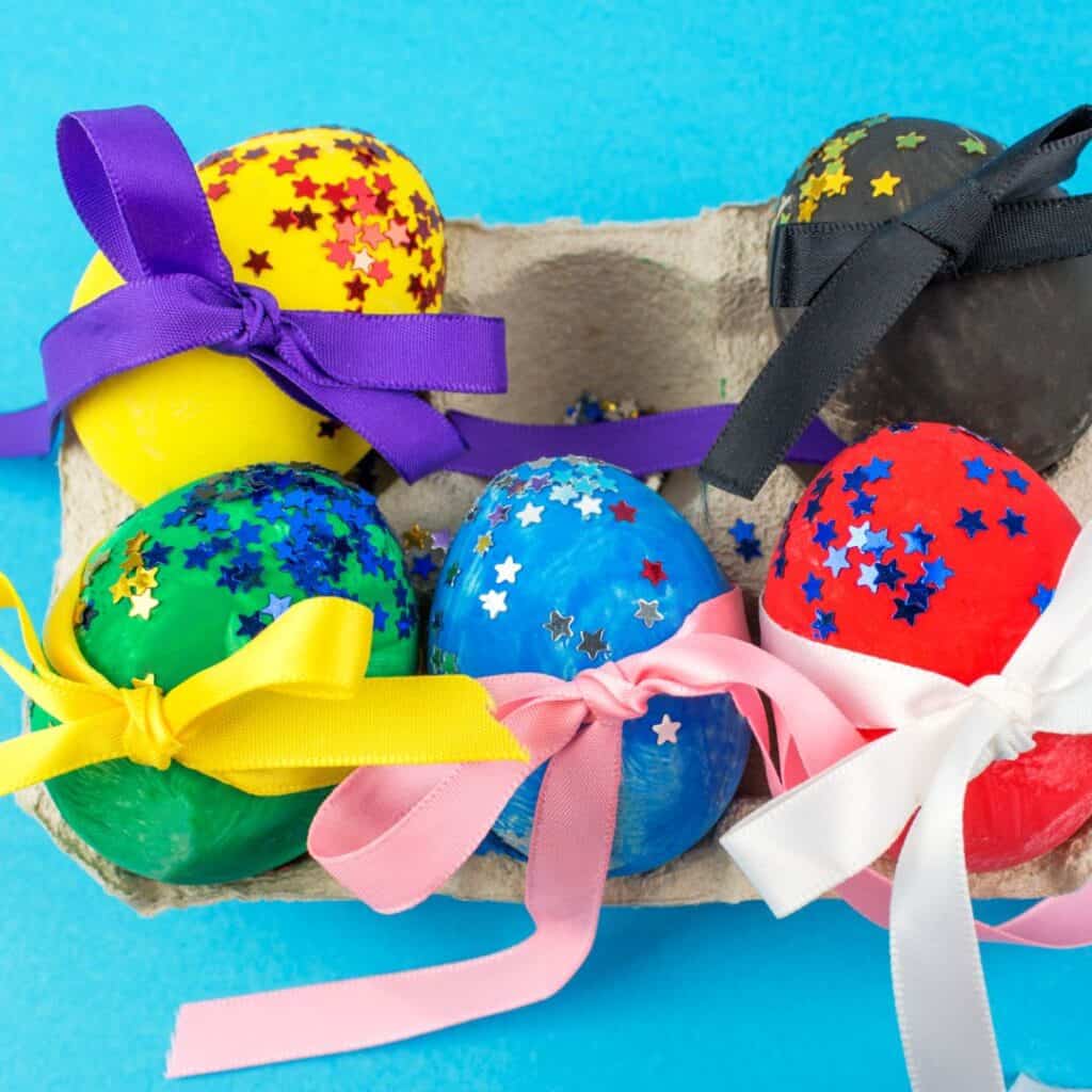 eggs painted different colors tied with ribbons for easter