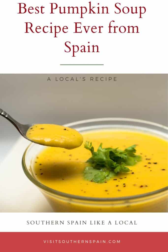a pin with the Best Pumpkin Soup Recipe Ever in a glass bowl with a spoon over it.