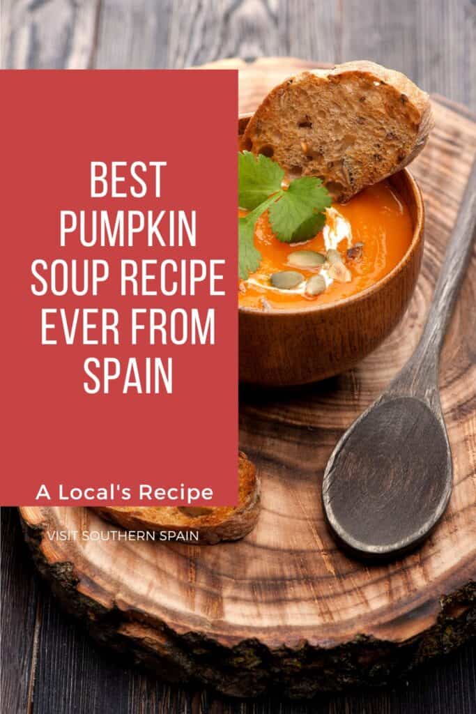 a pin with the Best Pumpkin Soup Recipe Ever in a wooden bowl.