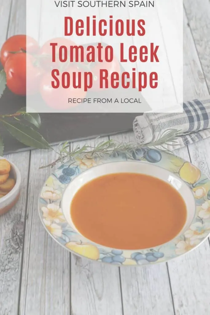 a pin with Tomato Leek Soup in a bowl with leek and tomatoes next to it.