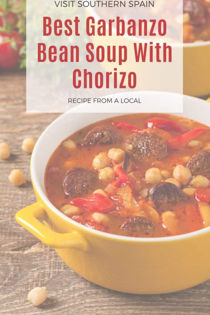 a pin with a garbanzo bean soup with chorizo in a yellow bowl.