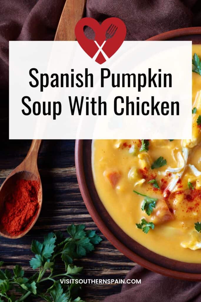 a pin with Spanish Pumpkin Soup With Chicken in a clay bowl with a spoon of paprika next to it.