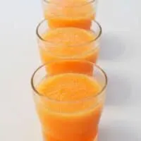 3 glass cups with cold melon soup
