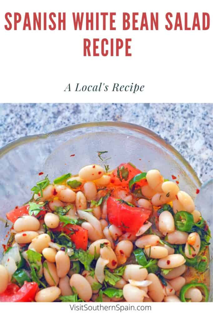a pin with a Spanish White Bean Salad Recipe in a glass bowl.