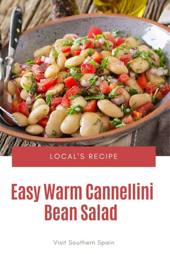 a pin with warm cannellini bean salad in a bowl.