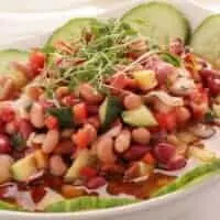 hot bean salad in a bowl with various vegetables