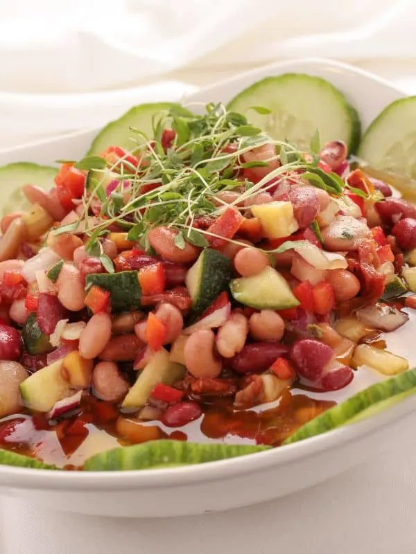 mixed bean salad in a bowl with various vegetables