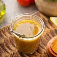 Spanish Salad Dressing in a small jar on a wooden board