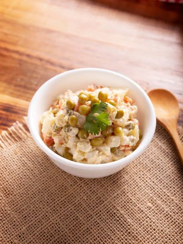 chicken potato salad in a bowl on a wooden table