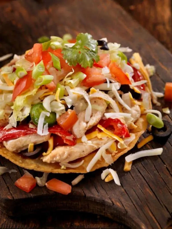 fajita chicken salad on a wooden board.