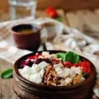 cranberry chicken pecan salad in a wooden bowl