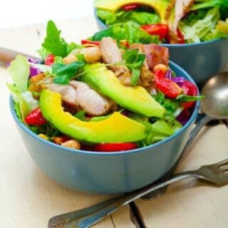 summer salad with chicken in 2 bowls. Healthy recipes from Spain