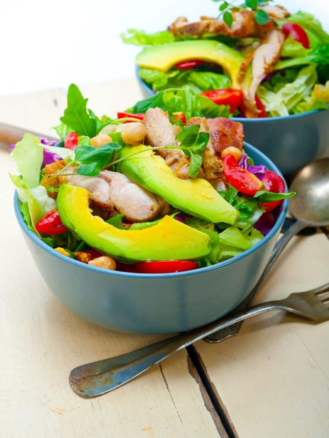 summer salad with chicken in 2 bowls