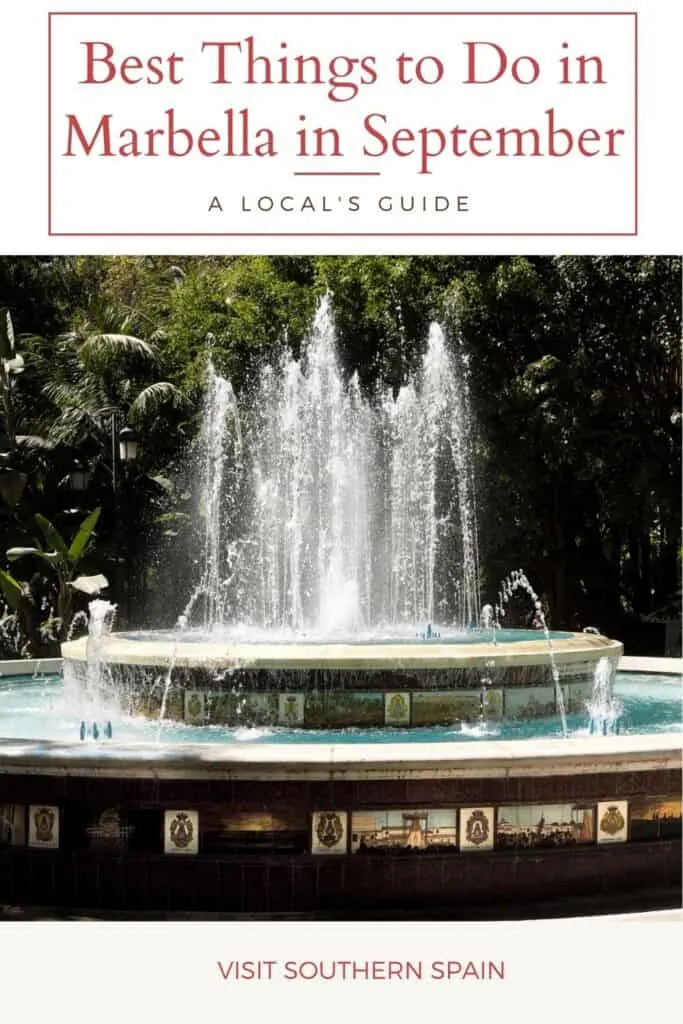 a fountain in the middle of a park surrounded by trees