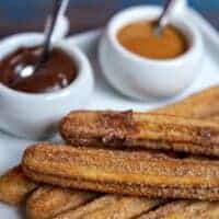 easy churros recipe served with 2 types of sauce