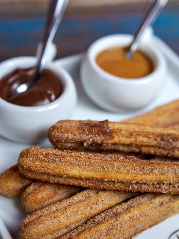 baked churros served with 2 types of sauce