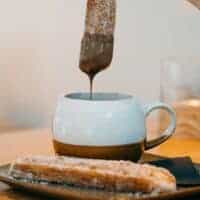 spanish dessert churros served with a cup of chocolate