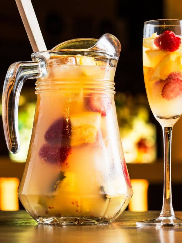 mango sangria recipe in a jar and a tall glass. Best Spanish alcoholic drinks