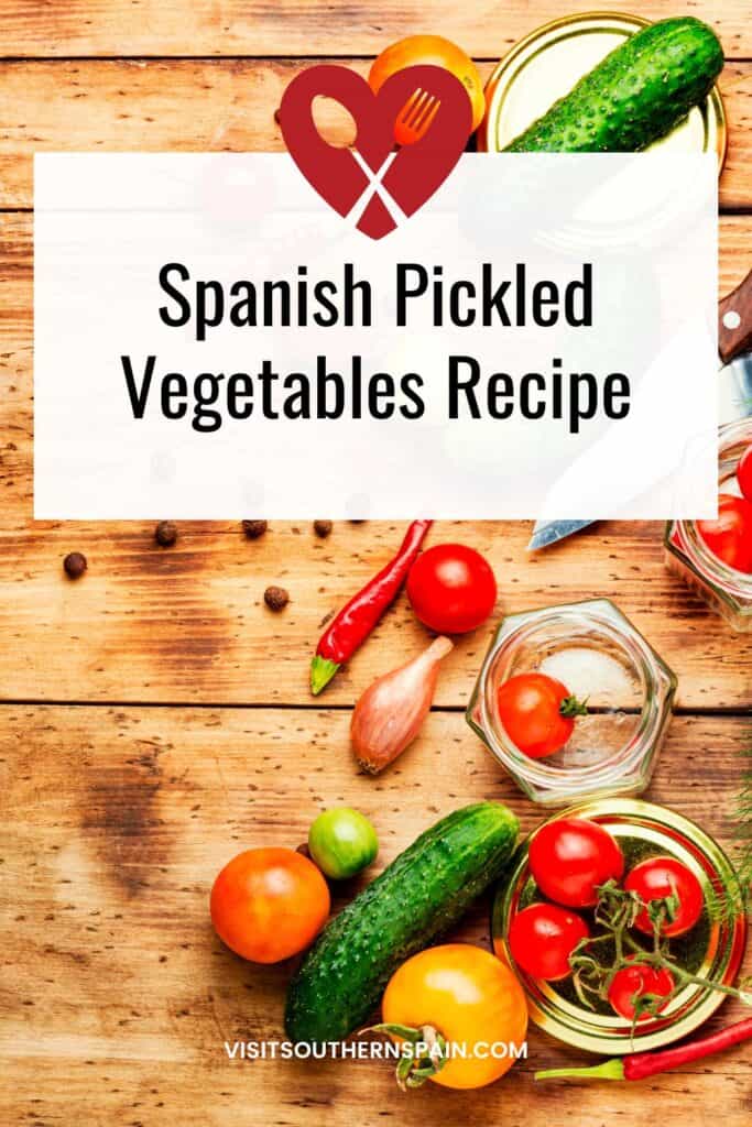 a pin with vegetables on a wooden table for the a pin with a closeup of spanish pickled vegetables