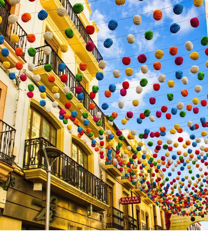 street in malaga decorated for the La Feria de Pedro Romero, Malaga weather in September