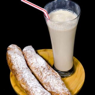 a cup of horchata served with fartons. Best Pastries from Spain