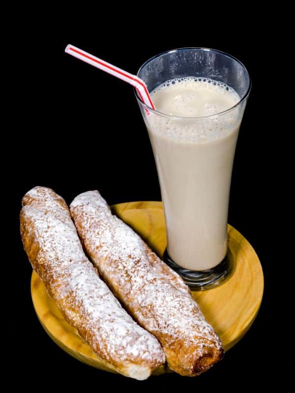 a cup of horchata served with fartons. Best Pastries from Spain